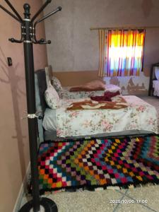 a bedroom with a bed with a colorful rug at Double Room in Telouet