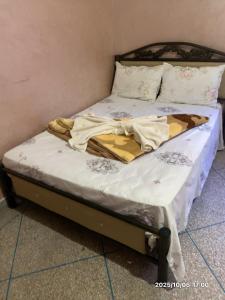 an unmade bed in a corner of a room at Double Room in Telouet
