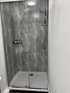 a shower stall with a glass door with a shower at Victoria Park in Bristol +30 photos