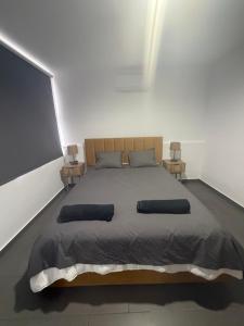 a bedroom with a large bed with two night stands at Venus sea view in Paphos +6 photos
