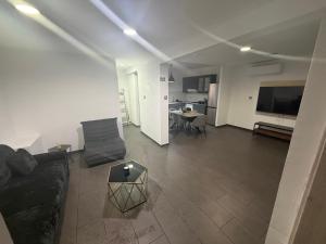 a living room with a couch and a table at Venus sea view in Paphos