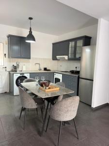 a kitchen with a table and chairs and a refrigerator at Venus sea view in Paphos