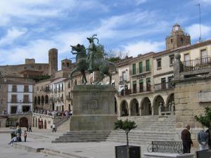 a statue of a woman on a horse in a city at El Aleznal in Trujillo