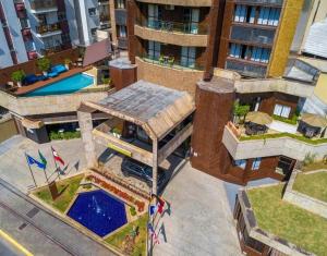 an overhead view of a building with a pool at Flat no coração de Joinville in Joinville