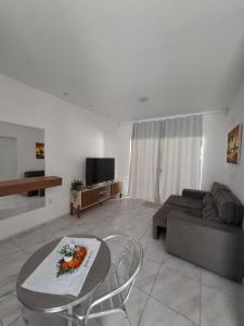 a living room with a couch and a table at Casa Lagoar in Jijoca de Jericoacoara