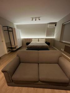 a living room with a couch and a bed at Flat no coração de Joinville in Joinville +7 photos