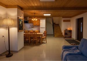 a living room and kitchen with a table and chairs at Hole in Zakopane
