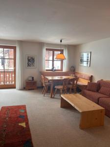 a living room with a table and a couch at Ganda Appartements in Gargellen