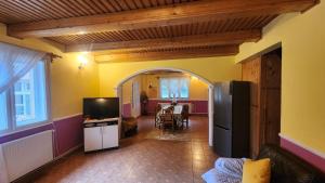 a living room with a kitchen and a dining room at Casa de vacanta Julius in Padis