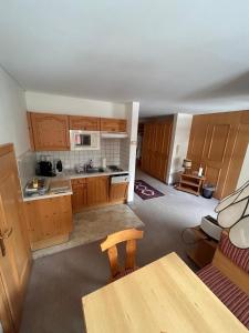 a large kitchen with wooden cabinets and a table at Ganda Appartements in Gargellen +13 photos