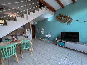 a living room with a table and a tv at Casa Gino in El Cotillo +11 photos