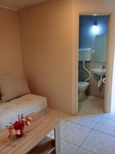 a room with a bed and a bathroom with a toilet at Apartments Nenadić in Utjeha