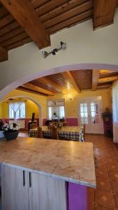 a living room with a table and a dining room at Casa de vacanta Julius in Padis