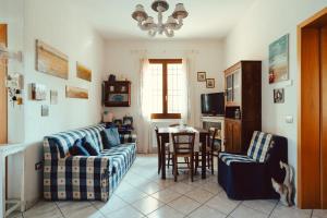 a living room with two couches and a table at Seaside Beach House with Private Parking in Punta Marina