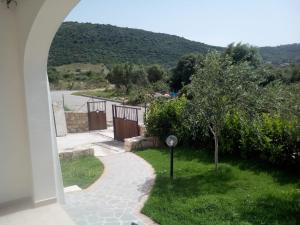 a view of a garden from a house with a walkway at Casa Dessi in Tanaunella