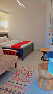 a living room with a bed and a couch at Shelvic Resort Ruiru in Ruiru +31 photos