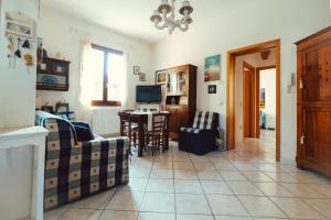a living room with a couch and a table at Seaside Beach House with Private Parking in Punta Marina