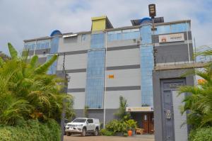 a building with a truck parked in front of it at Shelvic Resort Ruiru in Ruiru