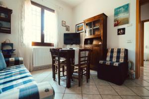 a living room with a dining room table and chairs at Seaside Beach House with Private Parking in Punta Marina