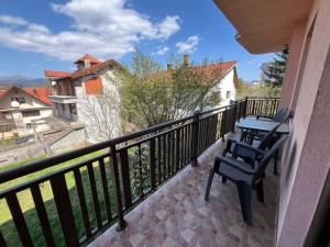a balcony with two chairs and a table at Queen Apartmani in Soko Banja