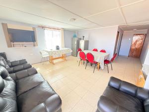 a living room with a couch and a table and chairs at Oasis terrenal Toconao in Toconao