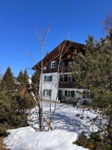 a building with snow in front of it at Ganda Appartements in Gargellen