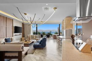 a living room with couches and a dining room at Bahiban Residences Oceanfront by Monyxbnb in Cruz de Huanacaxtle