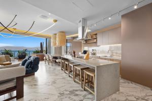 an open kitchen and living room with a view of the ocean at Bahiban Residences Oceanfront by Monyxbnb in Cruz de Huanacaxtle