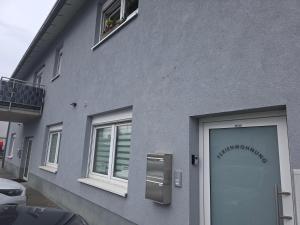 a gray building with a door and a window at SchwalbenNest Pfeifers OdenwaldNest in Rimbach
