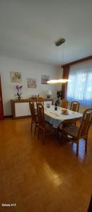 a dining room with a white table and chairs at Casa Camelia in Intragna
