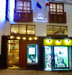 a store front of a building with windows and a balcony at Artezana Hotel in Cusco