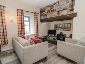 a living room with two couches and a tv at Carthouse in Weston-super-Mare