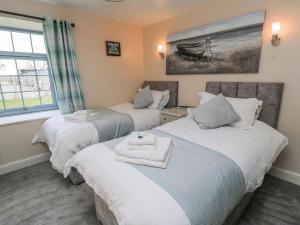 a room with two beds with towels on them at Carthouse in Weston-super-Mare