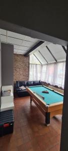 a room with a pool table and a couch at de bron in Beringen