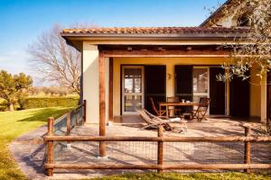 a patio with a table and a fence at Agriturismo Il Querciolo in Grosseto