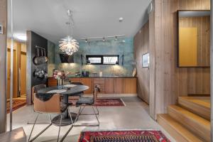 a kitchen with a table and chairs in a room at Håkøya Lodge in Tromsø