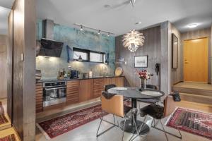 a kitchen with a table and a dining room at Håkøya Lodge in Tromsø