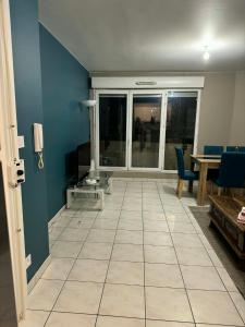 a living room with a large window and a tile floor at Apt Parisien in Vitry-sur-Seine