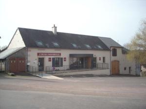 a large white building with a black roof at ESCALE MORVANDELLE studio 2 personnes in Saint-Brisson