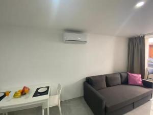 a living room with a couch and a table at Alaram Holidays House by Villas Rivero in Arguineguín