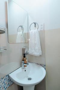 a bathroom with a white sink and a mirror at Chill Atacama in San Pedro de Atacama +10 photos