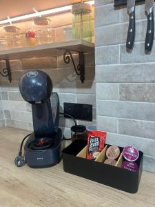 a coffee maker sitting next to a box of cookies at Lighthouse Apartman in Svilajnac