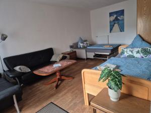 a living room with a couch and a table at Monteurwohnung Biedenkopf in Biedenkopf +10 photos