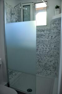 a shower with a glass door in a bathroom at Georgias house in Yerakiní