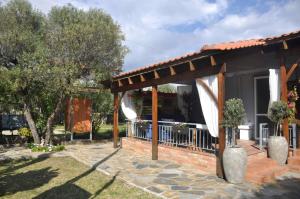 a house with a porch with a fence and trees at Georgias house in Yerakiní