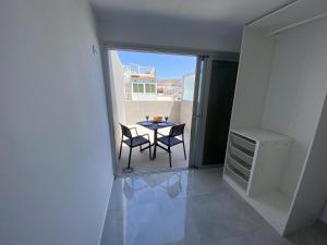a view of a balcony with a table and chairs at Alaram Holidays House by Villas Rivero in Arguineguín