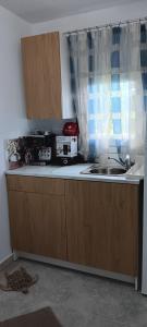 a kitchen counter with a microwave and a sink at Georgias house in Yerakiní +8 photos