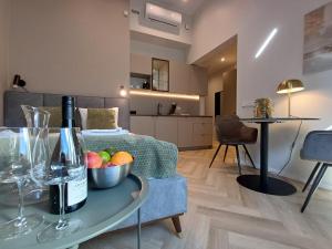 a living room with a table with a bottle of wine at Luise LuXe Suites in Tallinn