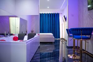 a room with a bed and a vanity with a chair at OLD STREET Luxury suite in Avola