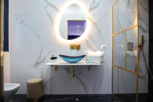 a bathroom with a sink and a mirror at OLD STREET Luxury suite in Avola +29 photos